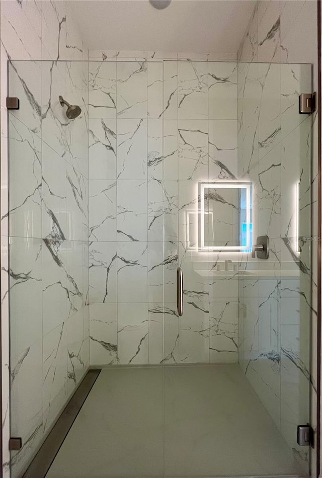 full bath featuring a marble finish shower