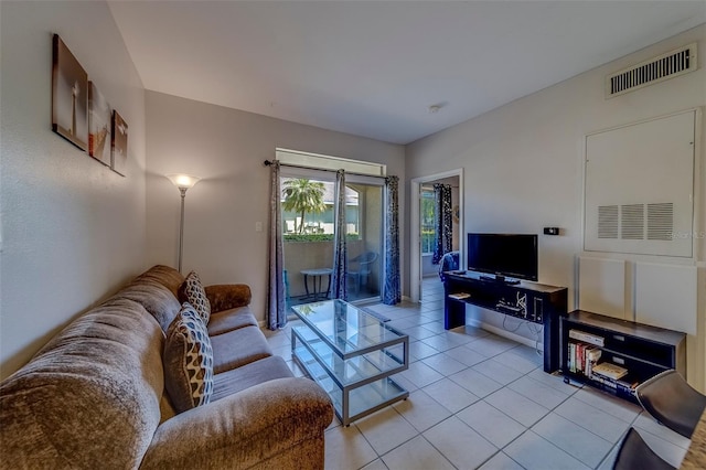 living room featuring light tile patterned flooring and visible vents