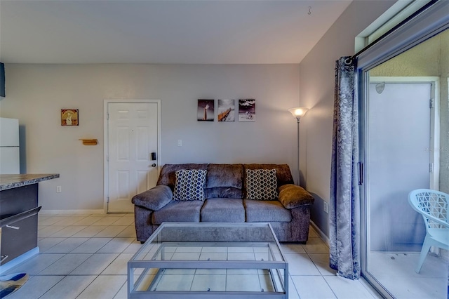 living room with baseboards and light tile patterned floors