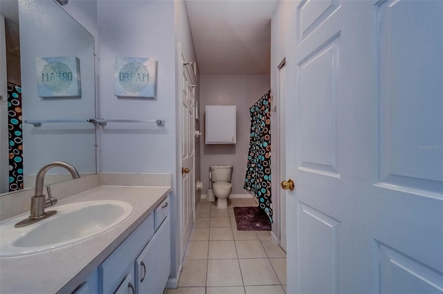 bathroom featuring tile patterned flooring, toilet, vanity, baseboards, and a shower with shower curtain