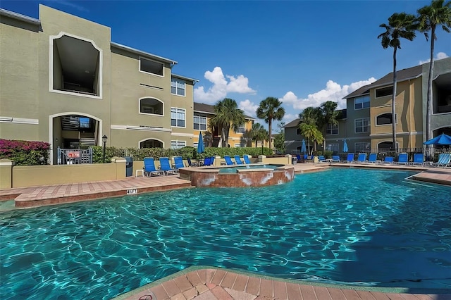 view of swimming pool with a pool with connected hot tub