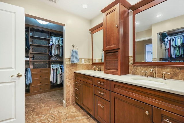 1004 Hollyberry Ct, Brandon, FL 33511 - bathroom featuring double vanity, a spacious closet, and recessed lighting