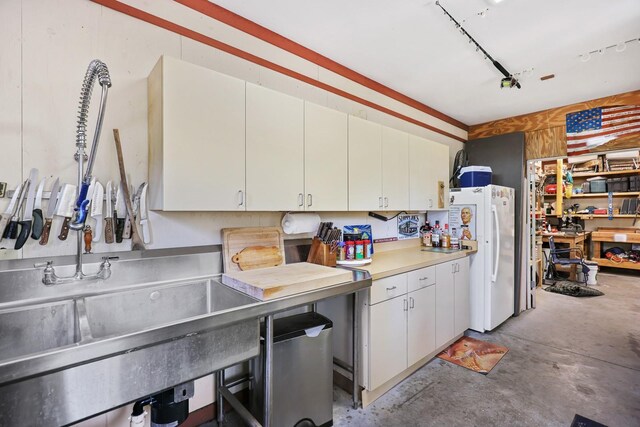 1004 Hollyberry Ct, Brandon, FL 33511 - kitchen with freestanding refrigerator, concrete flooring, and white cabinets
