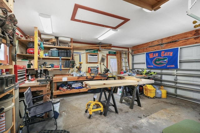 1004 Hollyberry Ct, Brandon, FL 33511 - garage featuring a wall mounted AC and a workshop area