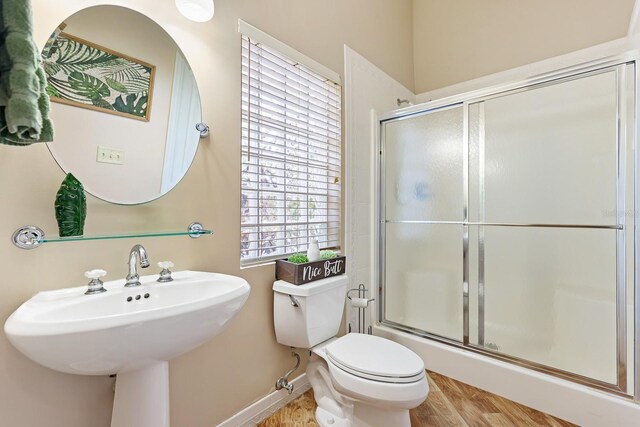 1004 Hollyberry Ct, Brandon, FL 33511 - full bathroom with a shower with shower door, toilet, baseboards, wood finished floors, and a sink