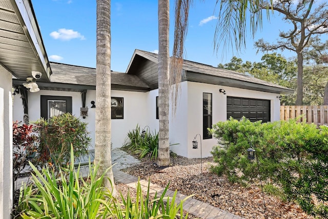 1004 Hollyberry Ct, Brandon, FL 33511 - view of front of house with stucco siding, a garage, and a shingled roof