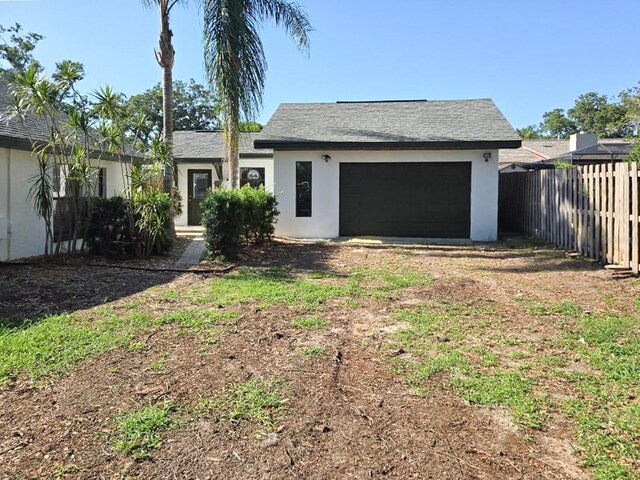 1004 Hollyberry Ct, Brandon, FL 33511 - single story home with stucco siding, a garage, and dirt driveway