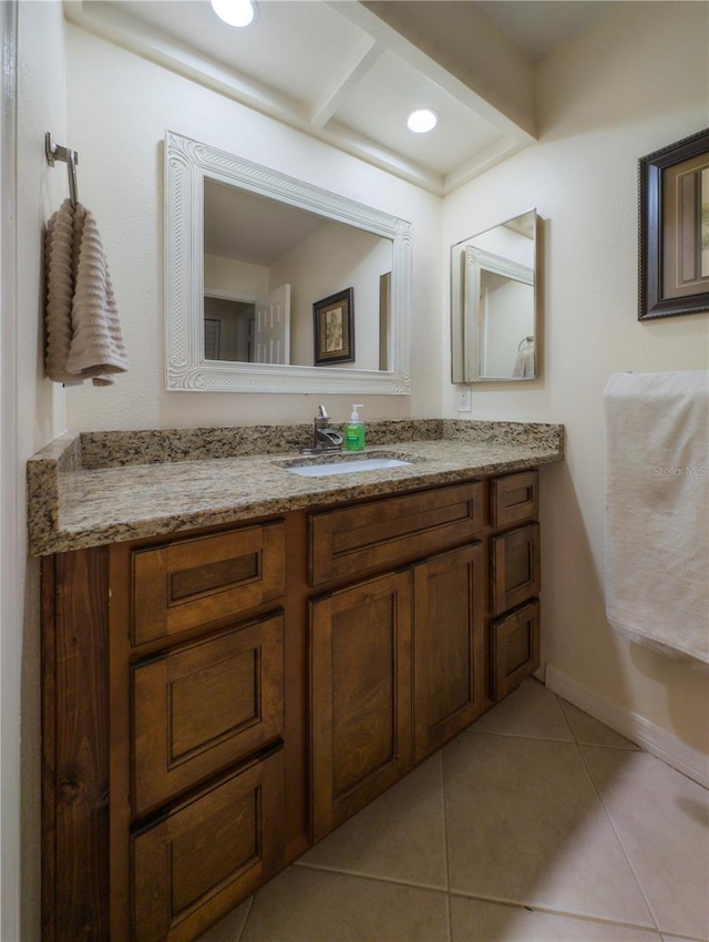 bathroom with vanity, tile patterned flooring, and baseboards