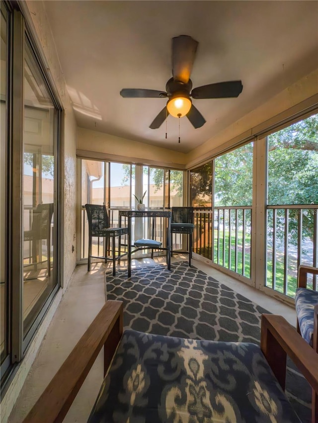sunroom featuring a ceiling fan