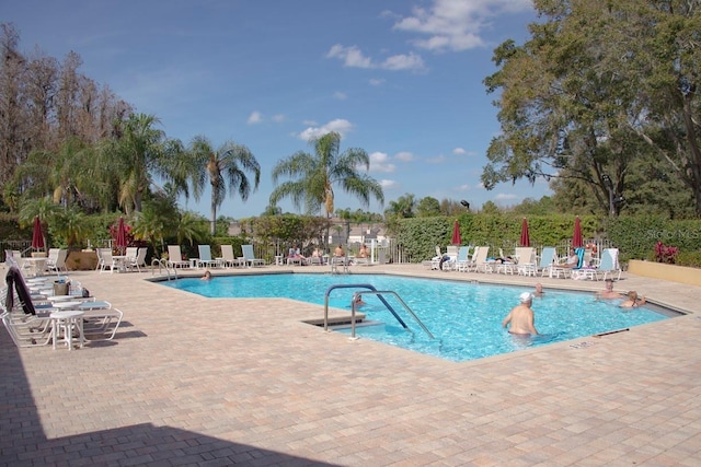 pool with fence and a patio area
