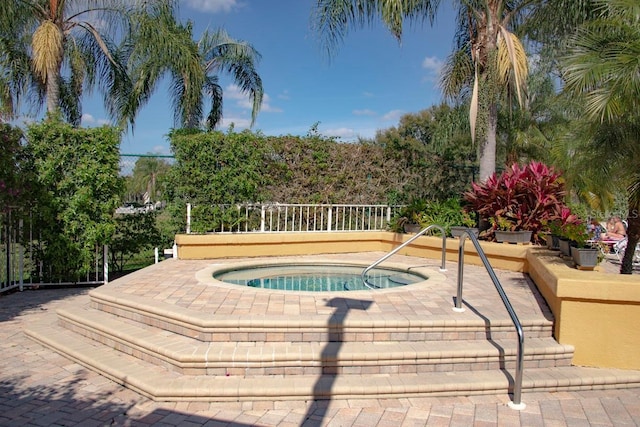 view of pool featuring an in ground hot tub