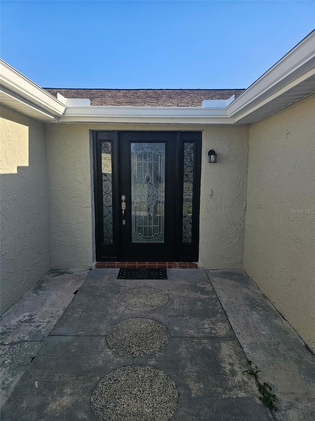 6241 Westport Dr, Port Richey, FL 34668 - doorway to property featuring stucco siding