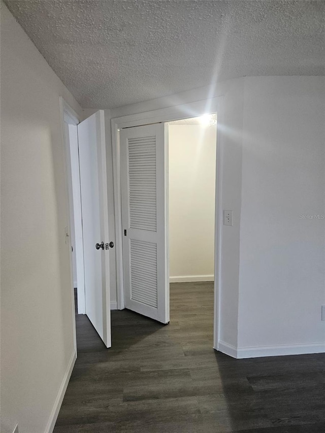 6241 Westport Dr, Port Richey, FL 34668 - spare room with baseboards, a textured ceiling, and dark wood-style floors