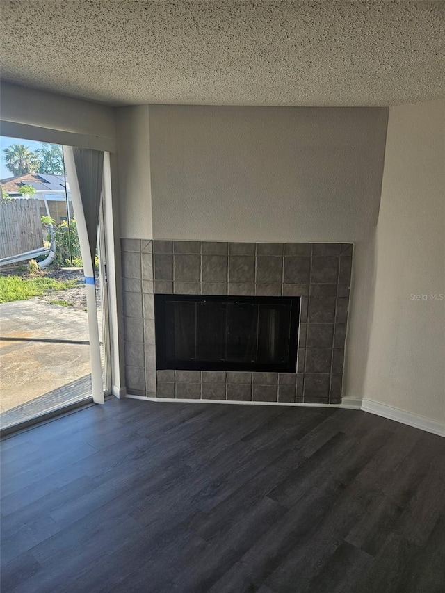 6241 Westport Dr, Port Richey, FL 34668 - room details featuring baseboards, a tiled fireplace, wood finished floors, and a textured ceiling