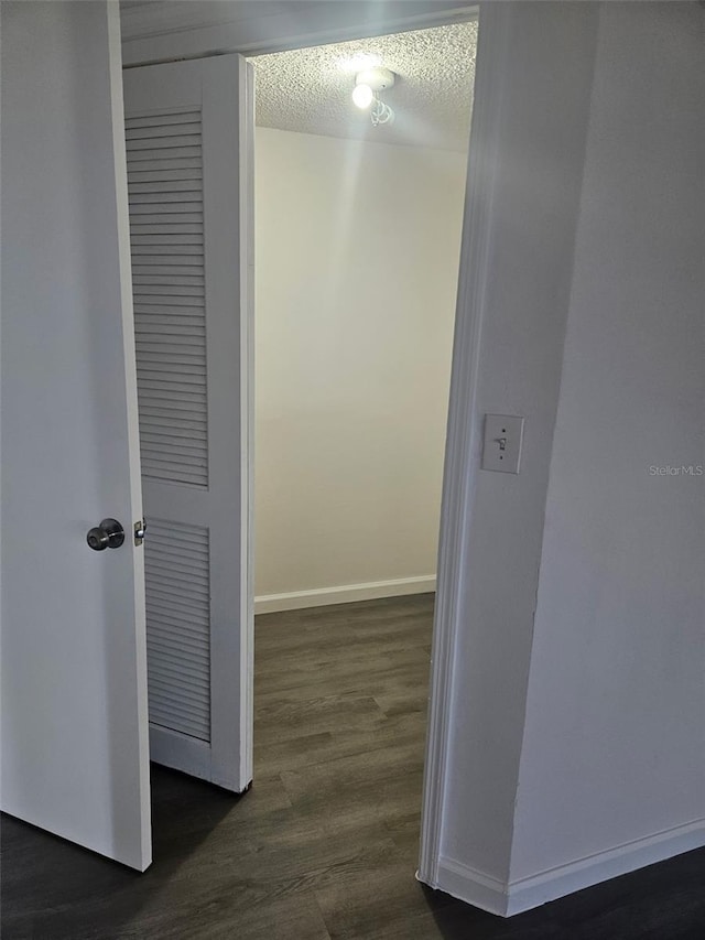6241 Westport Dr, Port Richey, FL 34668 - hall with a textured ceiling, baseboards, and dark wood-style flooring