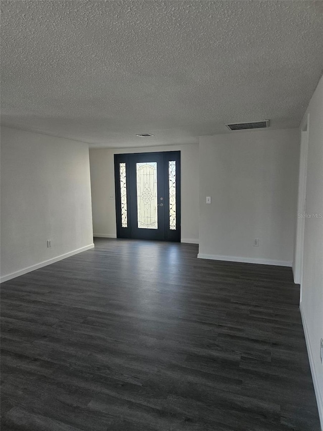 6241 Westport Dr, Port Richey, FL 34668 - spare room featuring dark wood finished floors and a textured ceiling