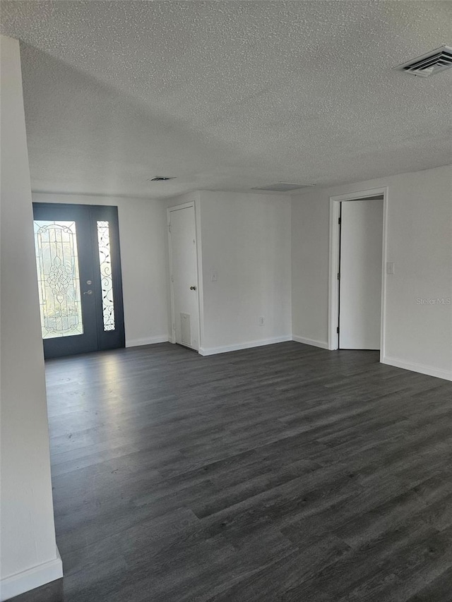 6241 Westport Dr, Port Richey, FL 34668 - spare room featuring baseboards, visible vents, a textured ceiling, and dark wood-type flooring