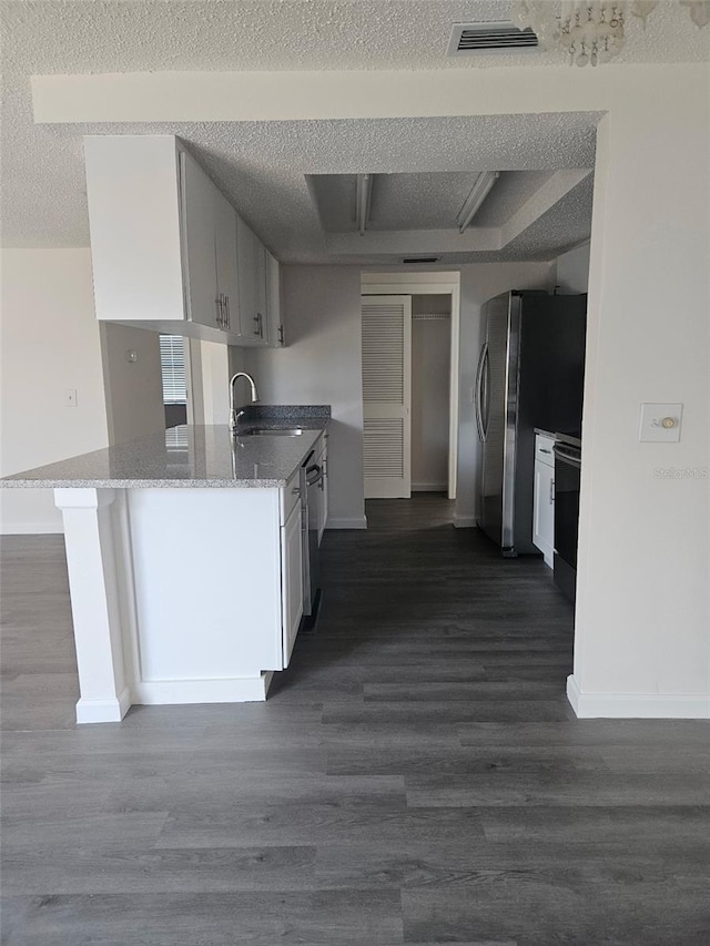6241 Westport Dr, Port Richey, FL 34668 - kitchen featuring a sink, baseboards, visible vents, light stone countertops, and dark wood-type flooring