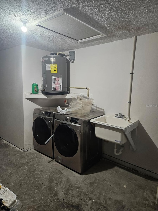 6241 Westport Dr, Port Richey, FL 34668 - laundry room with washing machine and clothes dryer, electric water heater, a textured ceiling, a sink, and laundry area