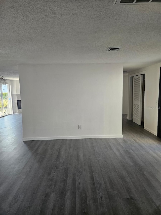 6241 Westport Dr, Port Richey, FL 34668 - spare room with visible vents, baseboards, a textured ceiling, and dark wood-style flooring