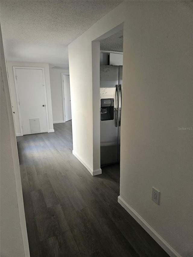 6241 Westport Dr, Port Richey, FL 34668 - hallway featuring dark wood finished floors, a textured ceiling, and baseboards