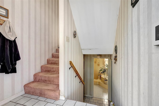 stairway featuring wallpapered walls, tile patterned floors, and baseboards