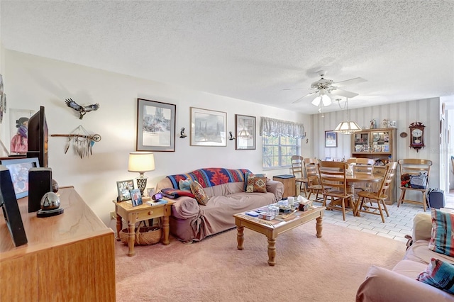 living room with carpet, a textured ceiling, and ceiling fan
