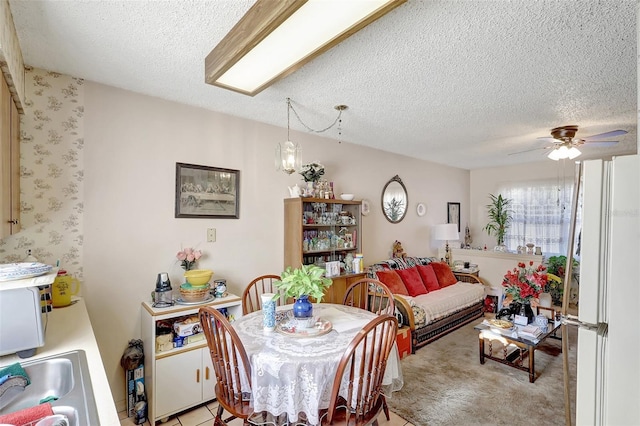 dining area featuring a textured ceiling and ceiling fan