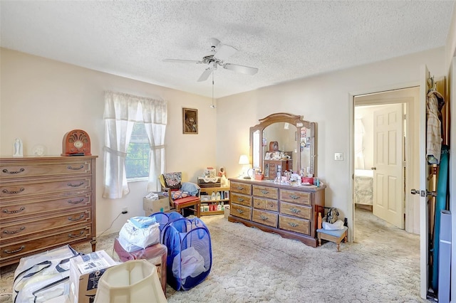 carpeted bedroom with a textured ceiling and ceiling fan