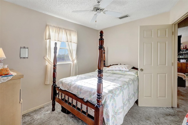 bedroom with visible vents, a textured ceiling, and light colored carpet