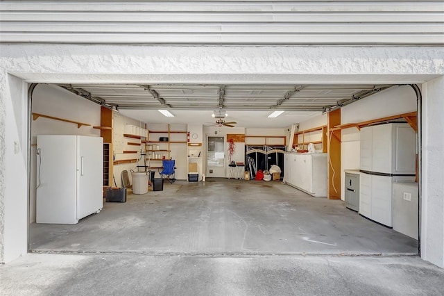 garage with freestanding refrigerator and a garage door opener