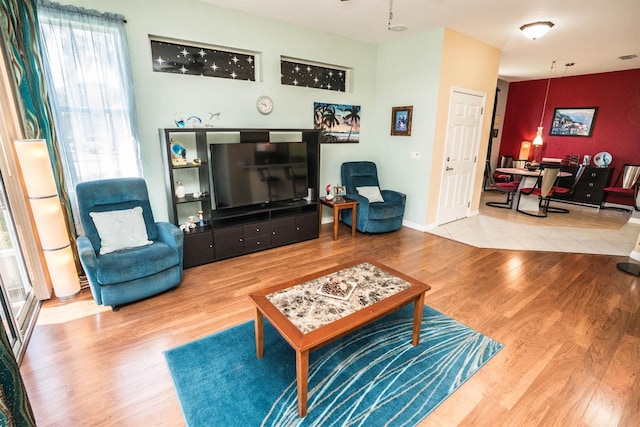 living area featuring wood finished floors and ceiling fan