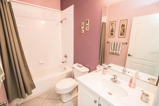 full bath featuring tile patterned flooring, a textured wall, toilet, vanity, and shower / tub combo with curtain