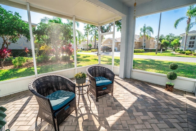 sunroom featuring a residential view