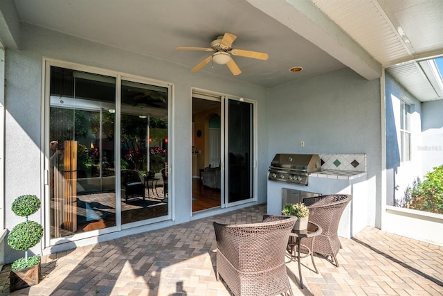 view of patio / terrace with a ceiling fan, exterior kitchen, and area for grilling