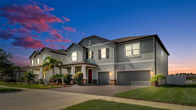 11720 Navajo Sandstone St, Riverview, FL 33579 - view of front of house with fence, an attached garage, stone siding, stucco siding, and driveway
