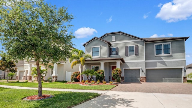 11720 Navajo Sandstone St, Riverview, FL 33579 - craftsman inspired home featuring a garage, decorative driveway, stucco siding, and stone siding