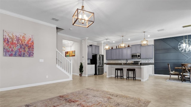 11720 Navajo Sandstone St, Riverview, FL 33579 - kitchen with an inviting chandelier, ornamental molding, and stainless steel appliances