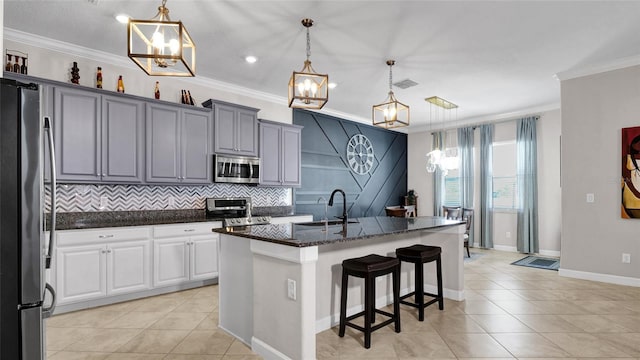 11720 Navajo Sandstone St, Riverview, FL 33579 - kitchen featuring crown molding, appliances with stainless steel finishes, light tile patterned flooring, and a sink