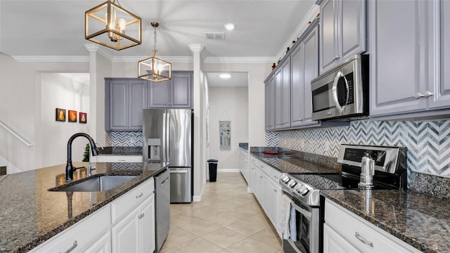 11720 Navajo Sandstone St, Riverview, FL 33579 - kitchen with appliances with stainless steel finishes, a sink, visible vents, decorative backsplash, and gray cabinetry