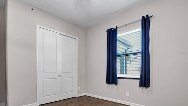 11720 Navajo Sandstone St, Riverview, FL 33579 - unfurnished bedroom featuring baseboards, dark wood-style floors, and a closet