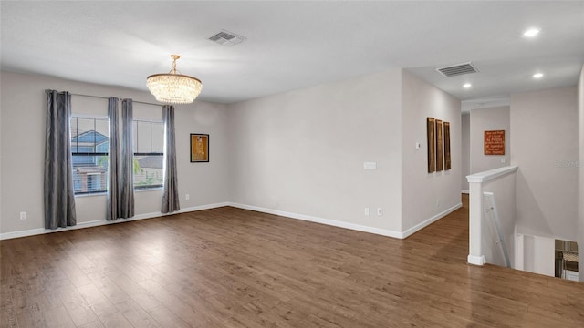 11720 Navajo Sandstone St, Riverview, FL 33579 - empty room with an inviting chandelier, baseboards, wood finished floors, and visible vents