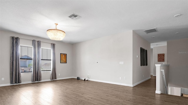 11720 Navajo Sandstone St, Riverview, FL 33579 - empty room featuring visible vents, baseboards, wood finished floors, and a chandelier