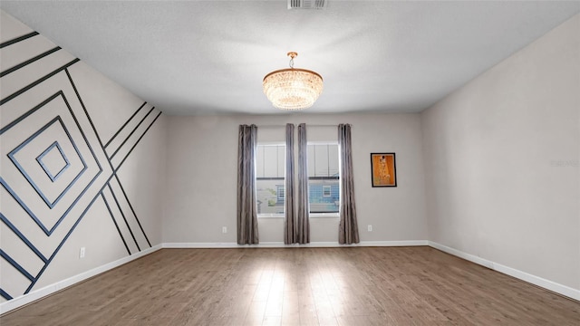 11720 Navajo Sandstone St, Riverview, FL 33579 - empty room with baseboards, a chandelier, and wood finished floors