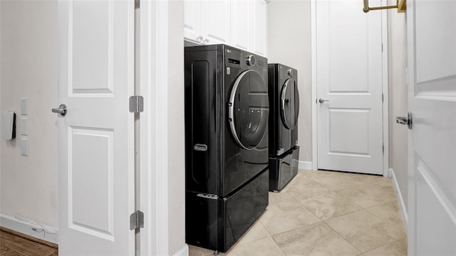 11720 Navajo Sandstone St, Riverview, FL 33579 - washroom featuring baseboards, cabinet space, washing machine and dryer, and light tile patterned flooring