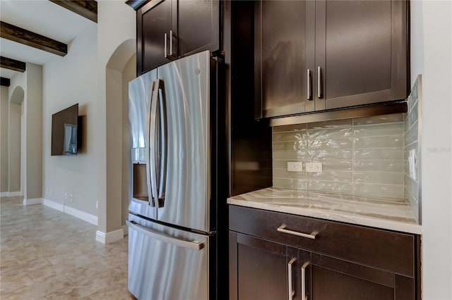 4975 Night Star Trl, Odessa, FL 33556 - kitchen with stainless steel fridge with ice dispenser, tasteful backsplash, light countertops, dark brown cabinetry, and beamed ceiling
