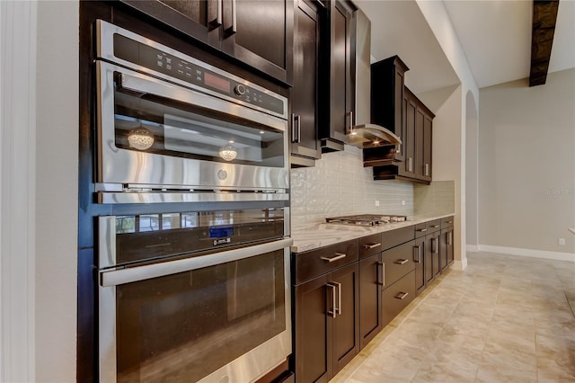 4975 Night Star Trl, Odessa, FL 33556 - kitchen featuring stainless steel appliances, decorative backsplash, baseboards, light stone countertops, and dark brown cabinetry