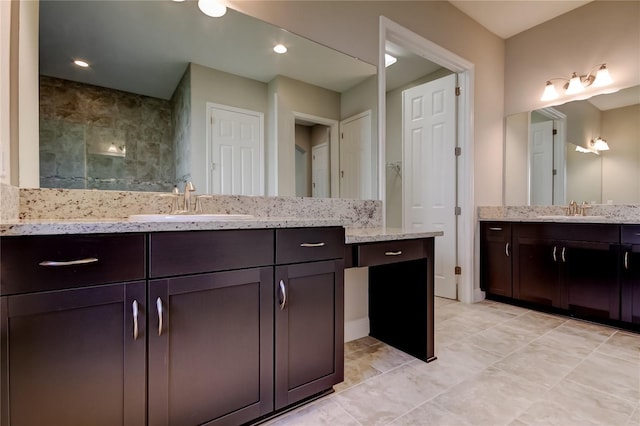 4975 Night Star Trl, Odessa, FL 33556 - bathroom featuring two vanities, tiled shower, and tile patterned floors