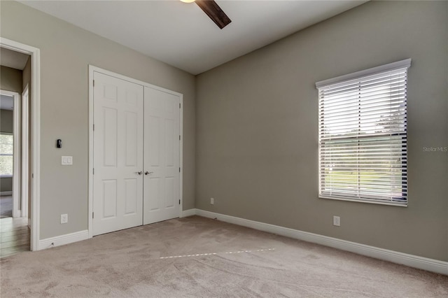 4975 Night Star Trl, Odessa, FL 33556 - unfurnished bedroom featuring light colored carpet, a closet, baseboards, and ceiling fan