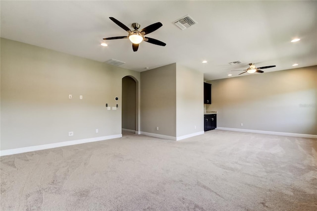4975 Night Star Trl, Odessa, FL 33556 - unfurnished living room with a ceiling fan, arched walkways, light carpet, baseboards, and recessed lighting